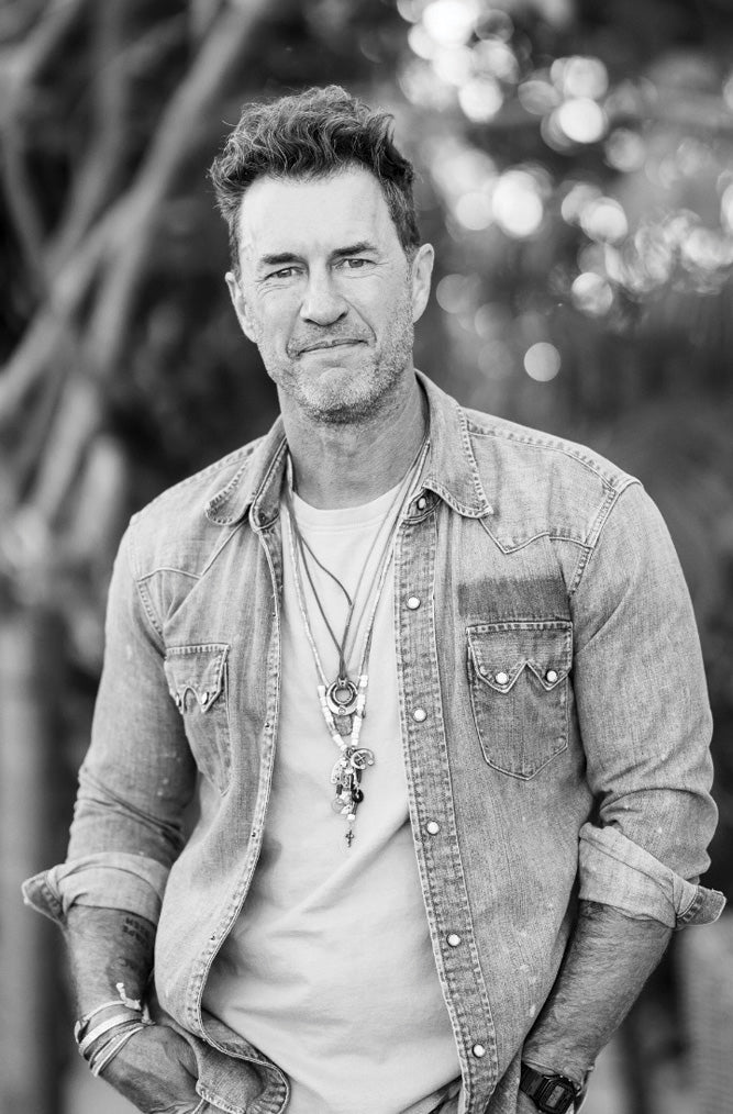 black and white portrait of a man in a jacket looking at the camera